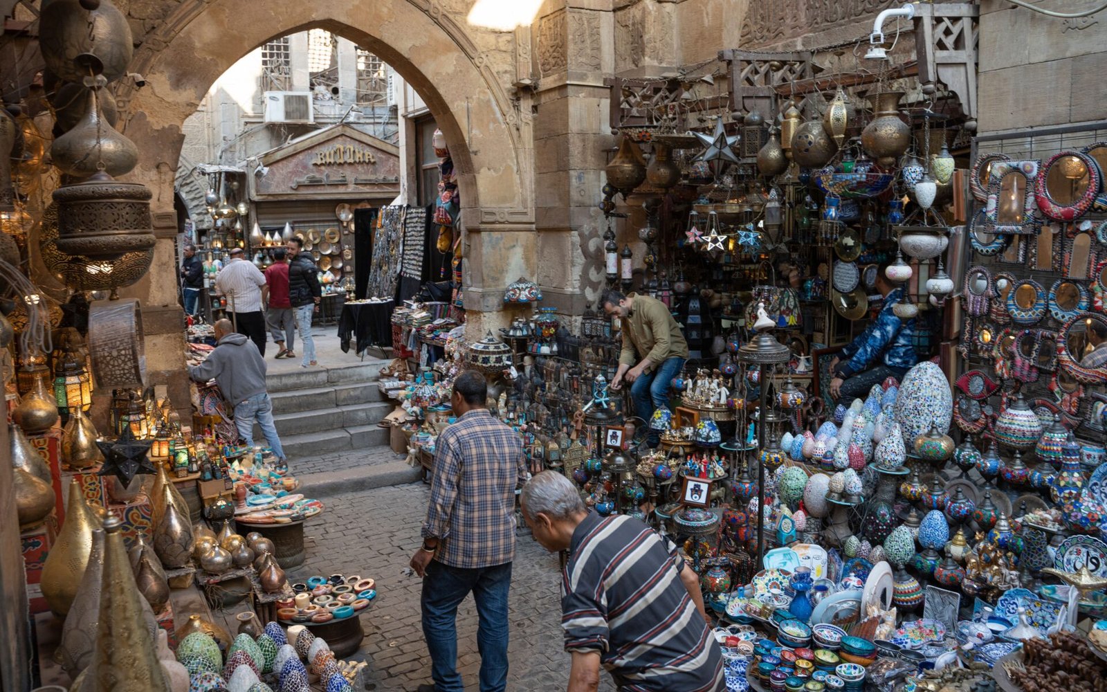 Vibrant street market with diverse Middle Eastern crafts and bustling activity.